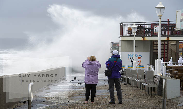 Photo by Guy Harrop. 20/08/16. A couple brave the elements to take photos of stormy waves hitting Westward Ho! in Devon at the weekend as storms hit across the UK . image copyright guy harrop info@guyharrop.com 07866 464282