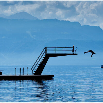 man diving into lake Switzerland © Guy Harrop 2024